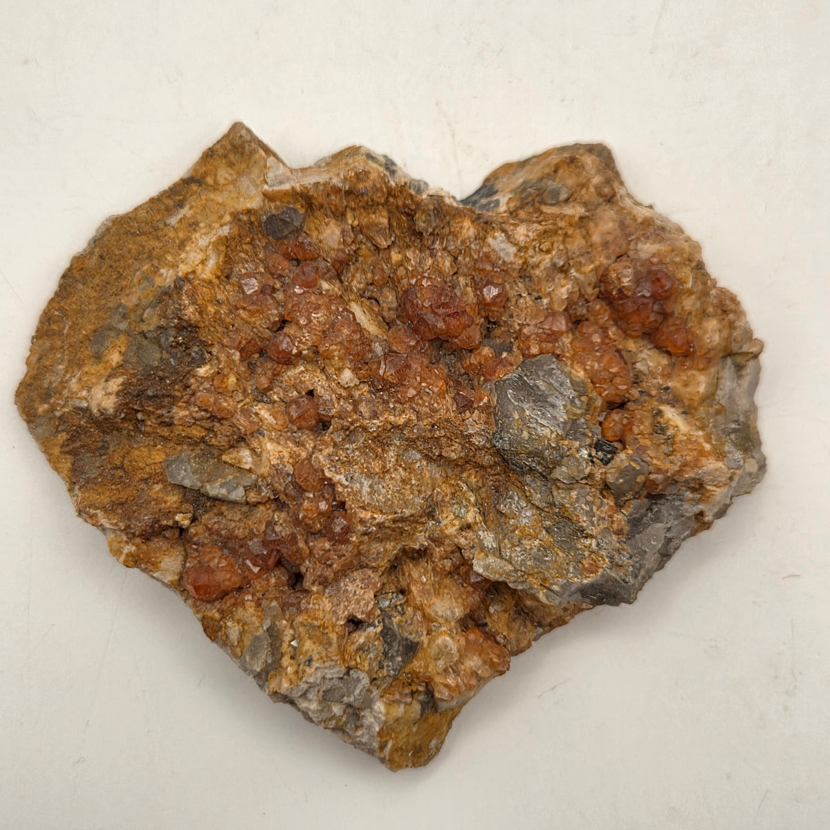 Close-up of spessartine garnet crystals on glassy smoky quartz