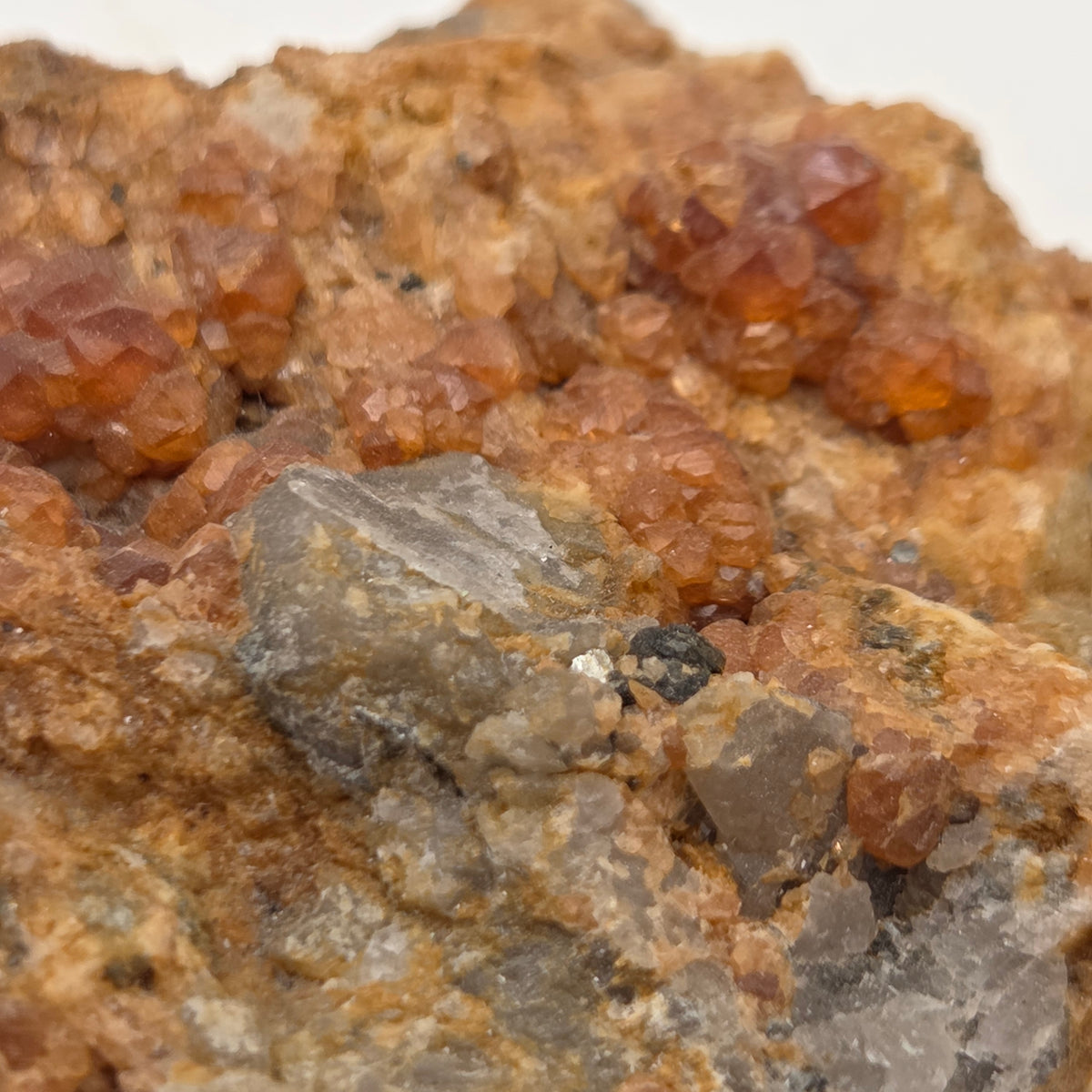 Side view of Fujian spessartine garnet and smoky quartz specimen
