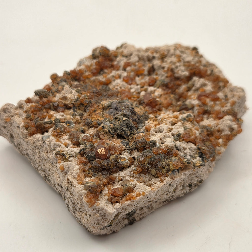 Orange-red spessartine garnet on feldspar and silvery mica matrix, Fujian, China