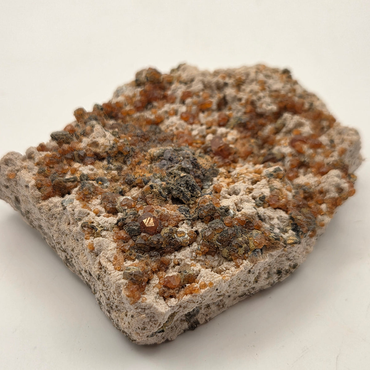 Orange-red spessartine garnet on feldspar and silvery mica matrix, Fujian, China
